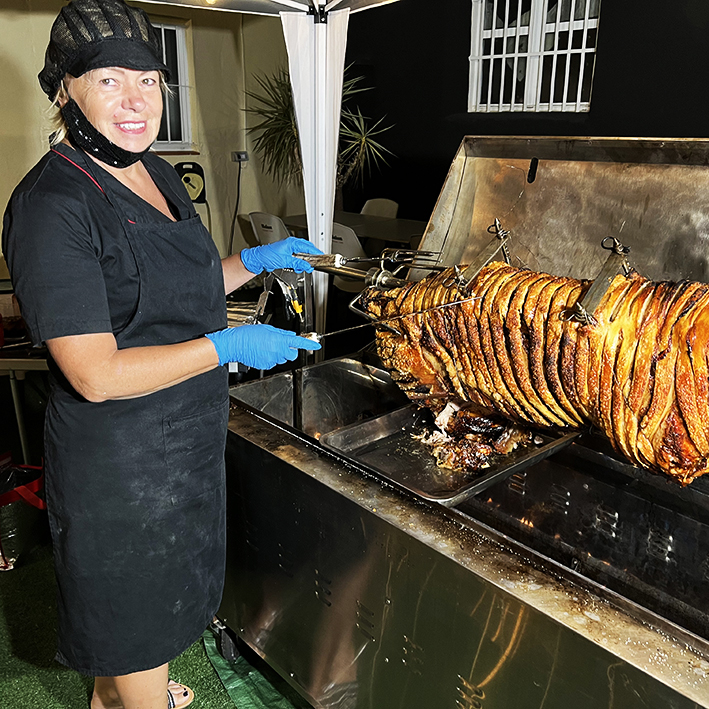 Julie is about to start serving the hog at an evening event